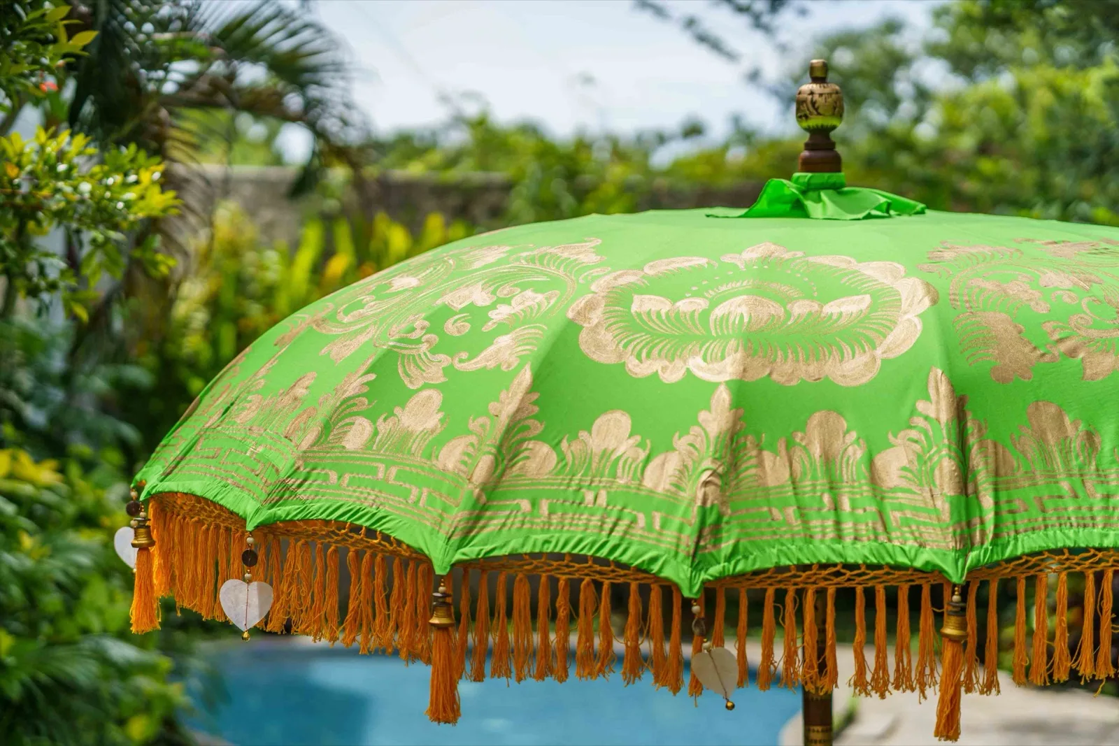 Ivory Coast Bali umbrella · Leaf green · saffron-orange tassel fringe